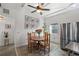 Bright dining area features a wooden table, decorative rug, stainless steel refrigerator, and natural light from the window at 29527 Maris Dr, Punta Gorda, FL 33982