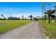 Long gravel driveway leading to the home and outbuildings, offering privacy and space at 29527 Maris Dr, Punta Gorda, FL 33982