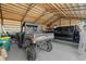 Spacious garage featuring an ATV, truck, and ample room for equipment and storage at 29527 Maris Dr, Punta Gorda, FL 33982