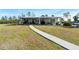 Charming single-story home with a inviting front porch and well-manicured lawn at 29527 Maris Dr, Punta Gorda, FL 33982