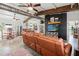 Open-concept living room with exposed beam ceiling, modern decor, and sleek concrete floors at 29527 Maris Dr, Punta Gorda, FL 33982