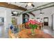 Living and dining area with exposed beams, concrete floors and modern fixtures at 29527 Maris Dr, Punta Gorda, FL 33982