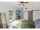 Bright main bedroom featuring a platform bed, concrete floors, flatscreen TV, and a barn door closet at 29527 Maris Dr, Punta Gorda, FL 33982