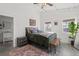 Bright main bedroom featuring a platform bed, concrete floors, neutral rug, and a view to the main bathroom at 29527 Maris Dr, Punta Gorda, FL 33982