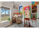 Bright studio featuring concrete floors, an abundance of paintings, and natural light from the window at 29527 Maris Dr, Punta Gorda, FL 33982