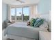 Light and airy bedroom with large windows and balcony overlooking lush landscaping at 3030 Grand Bay Blvd # 324, Longboat Key, FL 34228
