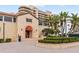 Beautiful building exterior with lush landscaping and a tile roof at 3030 Grand Bay Blvd # 324, Longboat Key, FL 34228