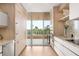 Bright modern kitchen with wood cabinets and a scenic balcony at 3030 Grand Bay Blvd # 324, Longboat Key, FL 34228