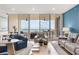 Bright living room with hardwood floors and expansive windows offer panoramic ocean views at 3030 Grand Bay Blvd # 324, Longboat Key, FL 34228