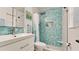 Stylish bathroom with blue mosaic tiles, a glass shower, and modern fixtures at 3112 Cambridge Ave # 6, Bradenton, FL 34207