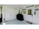 Covered carport area featuring ample storage, beach-themed decor, and a convenient access door to the home at 3112 Cambridge Ave # 6, Bradenton, FL 34207