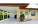 Carport entrance of a home with 'Siesta Key' sign, grilling area, and decorated front entrance with turtle ornament at 3112 Cambridge Ave # 6, Bradenton, FL 34207