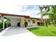 Inviting single-story home with a carport, well-maintained lawn, and attractive curb appeal showcasing beach-themed decorations at 3112 Cambridge Ave # 6, Bradenton, FL 34207