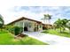 Charming single-story home featuring a covered carport, lush landscaping, and a welcoming front entrance with coastal accents at 3112 Cambridge Ave # 6, Bradenton, FL 34207