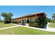 Clubhouse featuring a terracotta roof, manicured lawn, and inviting entrance at 3112 Cambridge Ave # 6, Bradenton, FL 34207