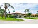 Well-maintained home featuring lush landscaping, terracotta roof, and a charming front entrance at 3112 Cambridge Ave # 6, Bradenton, FL 34207