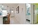 Hallway showcasing a kitchen, a door, and a view into a bathroom, highlighting modern design and natural light at 3112 Cambridge Ave # 6, Bradenton, FL 34207