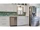 Kitchen with a stainless steel dishwasher, farmhouse sink, and stainless steel refrigerator at 3112 Cambridge Ave # 6, Bradenton, FL 34207