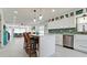 Bright kitchen with island seating, stainless steel appliances, and an open layout flowing into the living area at 3112 Cambridge Ave # 6, Bradenton, FL 34207