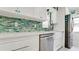 Bright kitchen featuring a stainless steel dishwasher, a subway tile backsplash, and farm style sink at 3112 Cambridge Ave # 6, Bradenton, FL 34207