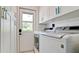 Bright laundry room with modern appliances, built-in cabinets, and convenient access to the outdoors at 3112 Cambridge Ave # 6, Bradenton, FL 34207