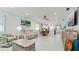 Bright living room featuring beach-themed decor, a ceiling fan, and white flooring and walls at 3112 Cambridge Ave # 6, Bradenton, FL 34207