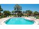 Inviting community pool surrounded by lush tropical landscaping and comfortable lounge chairs at 3112 Cambridge Ave # 6, Bradenton, FL 34207