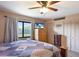 Comfortable bedroom with ceiling fan, natural light, and closet space; Quilt on bed at 3123 40Th W Ave, Bradenton, FL 34205