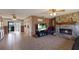 Open-concept living area with a stone fireplace, wood-paneled walls, and tile flooring at 3123 40Th W Ave, Bradenton, FL 34205