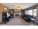 Inviting living room with a stone fireplace, wood-paneled walls, and tile flooring at 3123 40Th W Ave, Bradenton, FL 34205