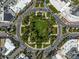Overhead shot of a beautifully landscaped roundabout with lush greenery and surrounding city streets at 322 S Washington Dr, Sarasota, FL 34236