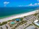 Overhead view capturing pristine beach and tranquil ocean waters, showcasing a community pool and convenient parking at 322 S Washington Dr, Sarasota, FL 34236