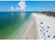 An aerial view captures a white sand beach meeting the ocean, with buildings and parking nearby at 322 S Washington Dr, Sarasota, FL 34236