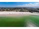 Expansive aerial view highlighting the shoreline and beach with people enjoying the ocean and sand at 322 S Washington Dr, Sarasota, FL 34236