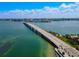 Aerial of a long bridge over turquoise water with a skyline in the distance on a bright, sunny day at 322 S Washington Dr, Sarasota, FL 34236