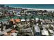 Aerial view of neighborhood, waterway, and beach with blue skies above at 322 S Washington Dr, Sarasota, FL 34236