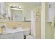 Bathroom includes sink, mirror, toilet and shower with built-in shelf and shower curtain at 322 S Washington Dr, Sarasota, FL 34236
