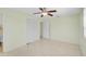 Bedroom with a ceiling fan, closet, and access to an attached bathroom, offering comfort and privacy at 322 S Washington Dr, Sarasota, FL 34236