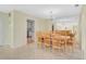 Dining room with chandelier lighting, light walls, and view of kitchen at 322 S Washington Dr, Sarasota, FL 34236