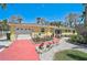 Charming yellow single-story home featuring a red driveway and well-manicured landscaping at 322 S Washington Dr, Sarasota, FL 34236