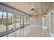 Enclosed lanai with wood paneled walls and ceiling, terrazzo floor, and glass windows at 322 S Washington Dr, Sarasota, FL 34236
