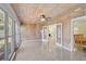 Enclosed lanai with wood paneled walls and ceiling, terrazzo floor, and glass windows at 322 S Washington Dr, Sarasota, FL 34236