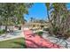 Charming yellow single-story home with a red driveway and beautifully landscaped front yard at 322 S Washington Dr, Sarasota, FL 34236