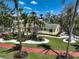 Well-maintained yard with lush landscaping including palm trees, shrubs, and rocks at 322 S Washington Dr, Sarasota, FL 34236