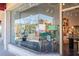 Inviting gallery entrance with large windows and an assortment of art displayed inside the Giving Tree Gallery at 322 S Washington Dr, Sarasota, FL 34236