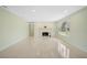 Spacious living room with fireplace, a large window for natural light, and light terrazzo floors at 322 S Washington Dr, Sarasota, FL 34236