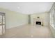 Large, naturally lit living room with a fireplace, built-in shelving, and light colored terrazzo flooring at 322 S Washington Dr, Sarasota, FL 34236