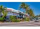 Street view featuring the Columbia Restaurant with outdoor seating, framed by lush palm trees and blue skies at 322 S Washington Dr, Sarasota, FL 34236