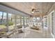 Cozy sunroom with lots of natural light from the many windows and a neutral color scheme at 322 S Washington Dr, Sarasota, FL 34236