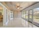 Bright sunroom features many windows, wood accents, and a ceiling fan at 322 S Washington Dr, Sarasota, FL 34236